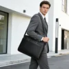 Black cowhide business briefcase style G5144 worn with shoulder strap