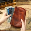 Brown cowhide leather pouch style Q8081 holding a phone cards and cash