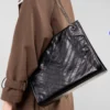 woman carrying black cowhide hobo crossbody purse style S1008